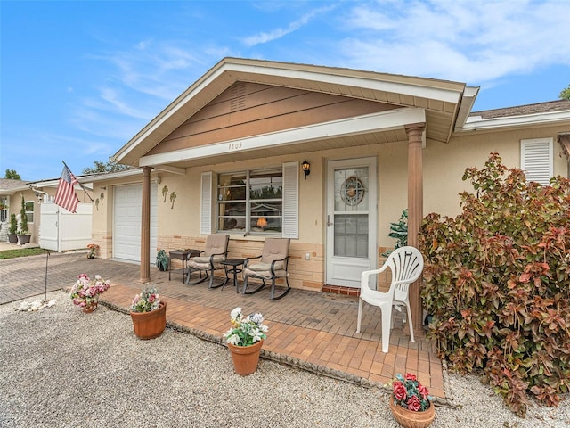 view of front facade with covered porch and a garage