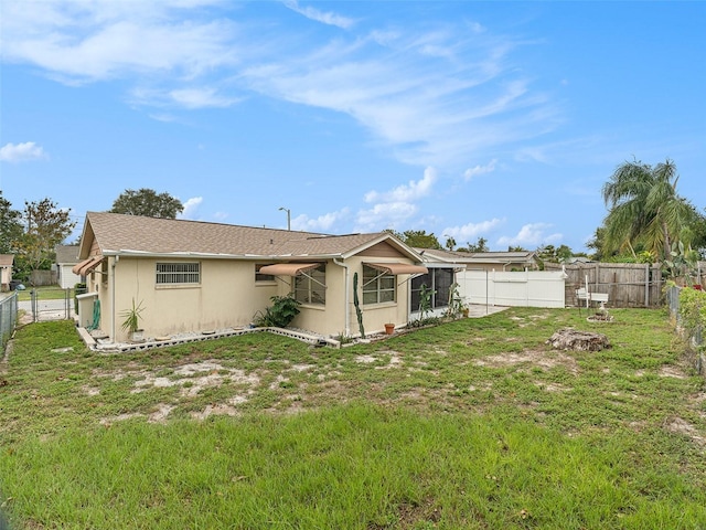 back of house with a lawn