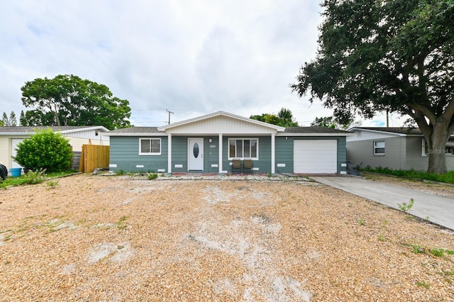 ranch-style house with covered porch and a garage