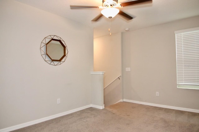 spare room with light carpet and ceiling fan