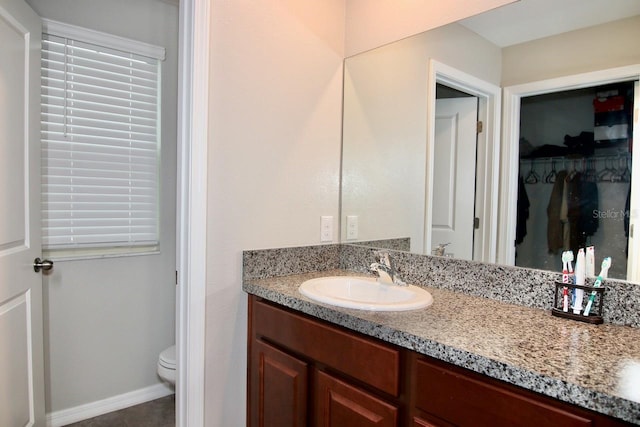 bathroom featuring tile patterned floors, vanity, and toilet