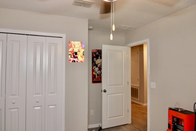 bedroom with carpet flooring, ceiling fan, and a closet