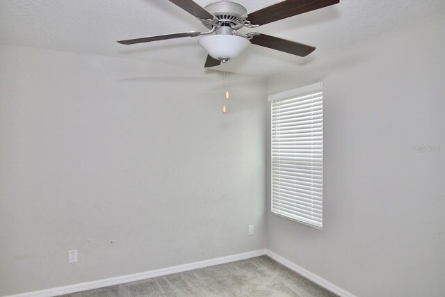 empty room featuring light carpet and ceiling fan