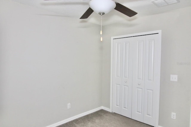 unfurnished bedroom featuring carpet flooring, ceiling fan, and a closet