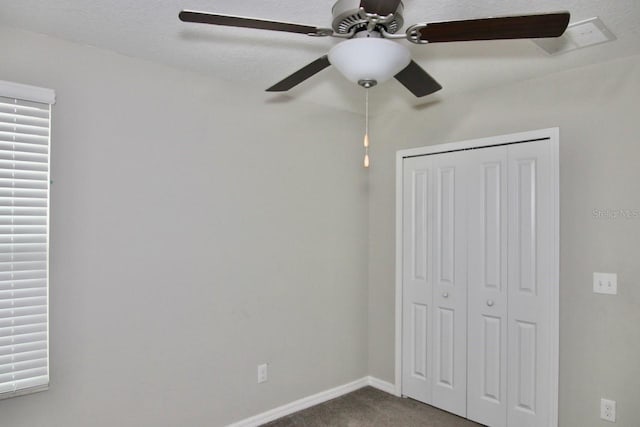 unfurnished bedroom featuring carpet flooring, a closet, and ceiling fan