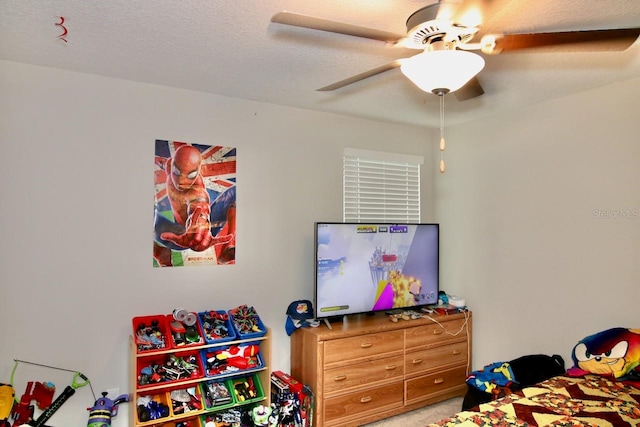 carpeted bedroom featuring ceiling fan and a textured ceiling