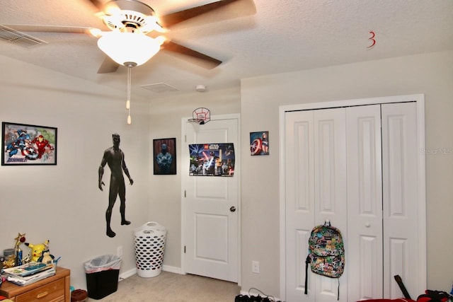 interior space with a textured ceiling, a closet, and ceiling fan