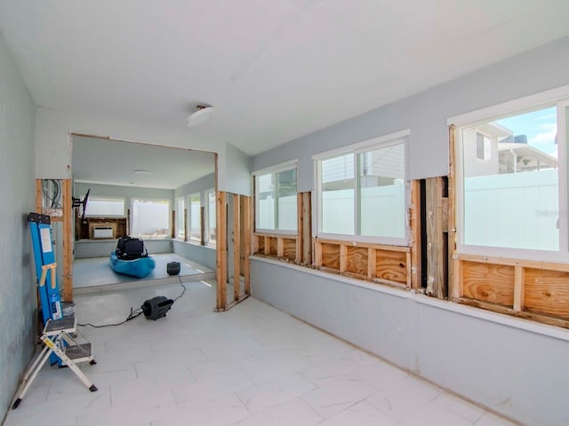 unfurnished sunroom with plenty of natural light