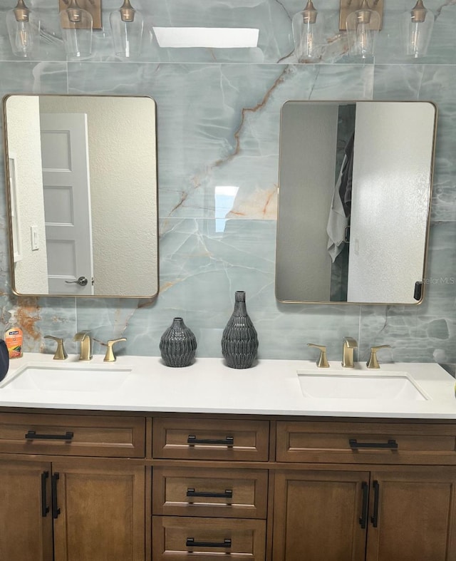 bathroom featuring a sink, double vanity, and tasteful backsplash