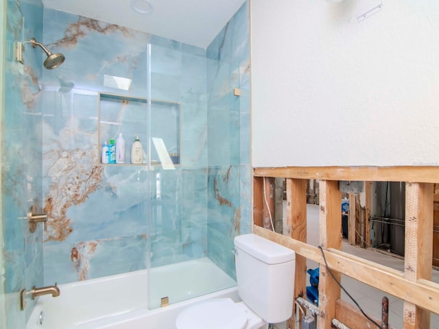 bathroom with shower / bath combination with glass door and toilet
