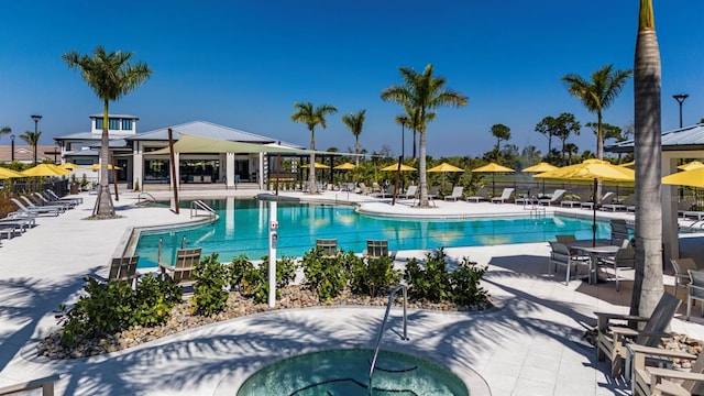 view of swimming pool with a community hot tub and a patio