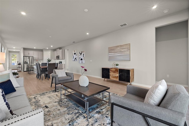 living room with light hardwood / wood-style flooring