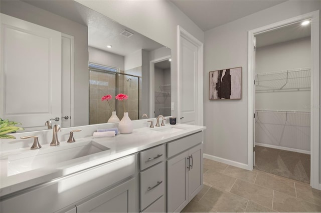 bathroom featuring vanity, an enclosed shower, and tile patterned floors