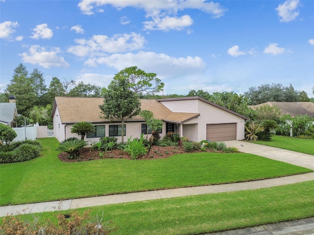 single story home featuring a garage and a front lawn