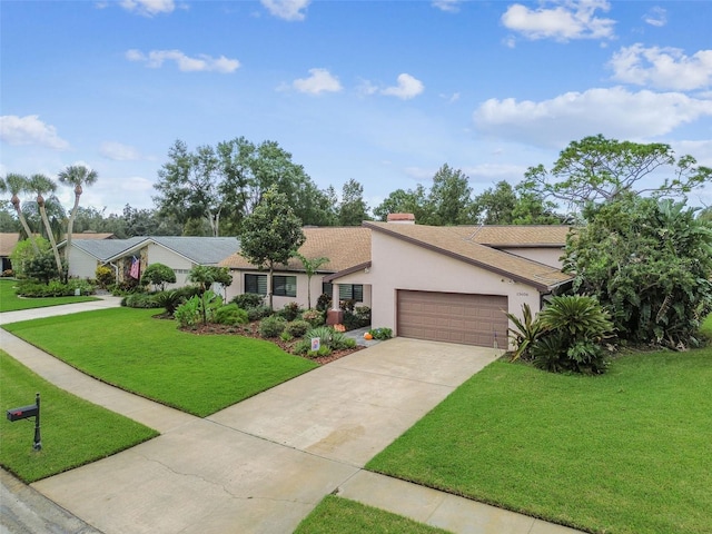 ranch-style house featuring a garage and a front yard