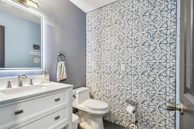 bathroom featuring vanity and toilet