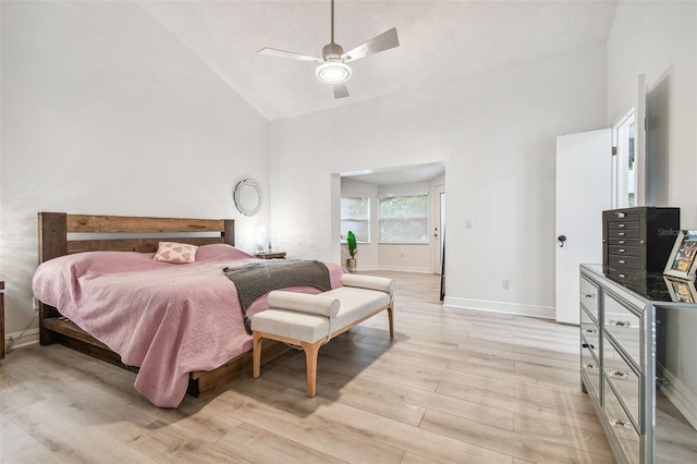 bedroom featuring high vaulted ceiling, light wood-type flooring, and ceiling fan