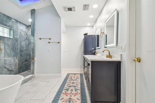 bathroom featuring vanity, separate shower and tub, tile patterned flooring, and a textured ceiling