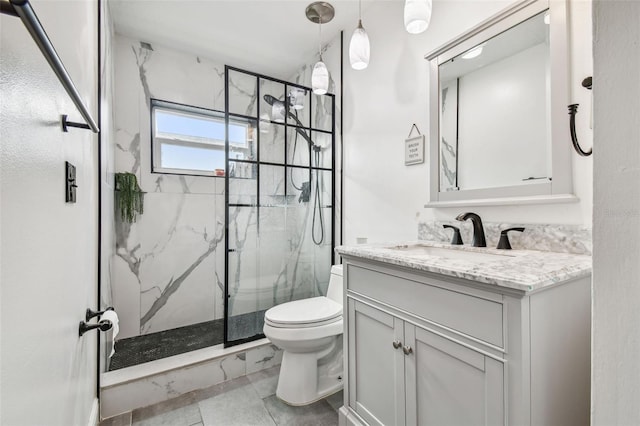 bathroom featuring walk in shower, vanity, toilet, and tile patterned flooring