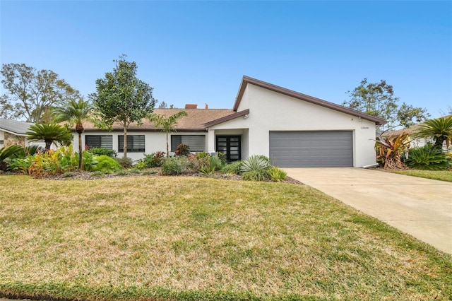 ranch-style house with a garage and a front yard