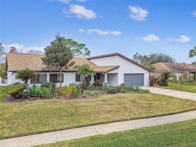 single story home featuring a garage and a front lawn