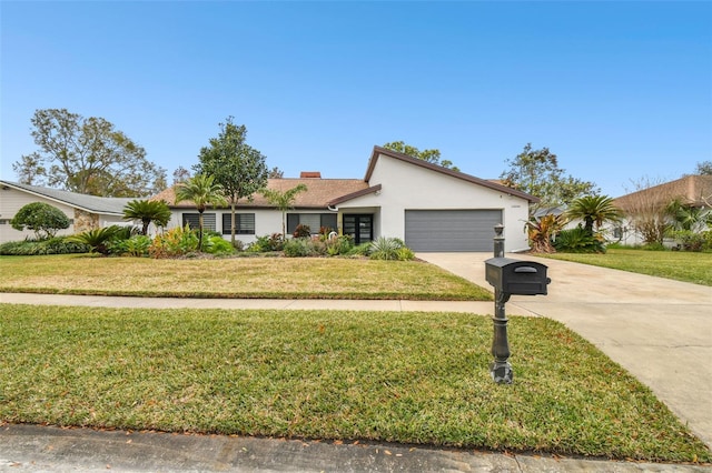 single story home with a garage and a front lawn