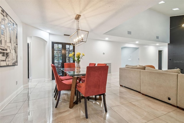 dining room featuring a textured ceiling and french doors