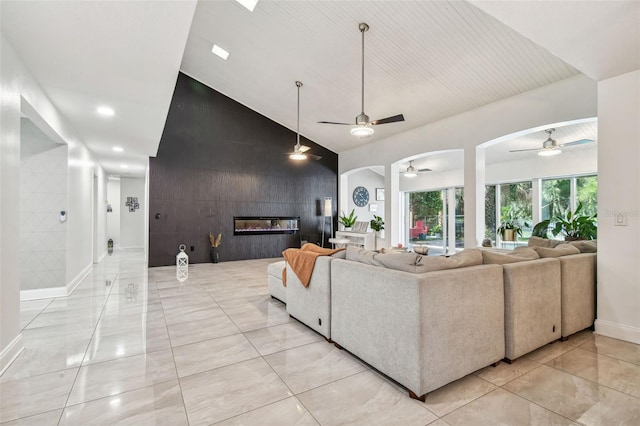 living room featuring vaulted ceiling and a large fireplace