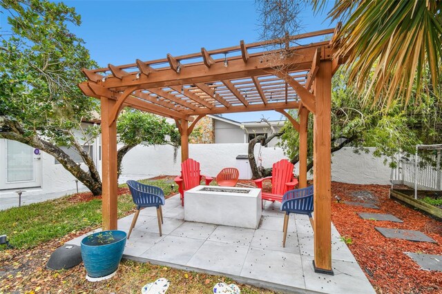 view of patio featuring a pergola and a fire pit