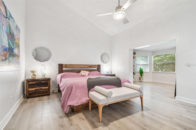 bedroom featuring high vaulted ceiling, light hardwood / wood-style floors, and ceiling fan