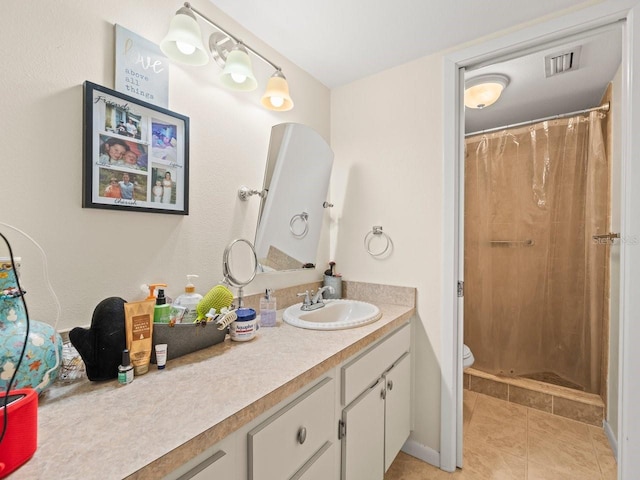 bathroom featuring tile patterned floors, toilet, vanity, and a shower with shower curtain