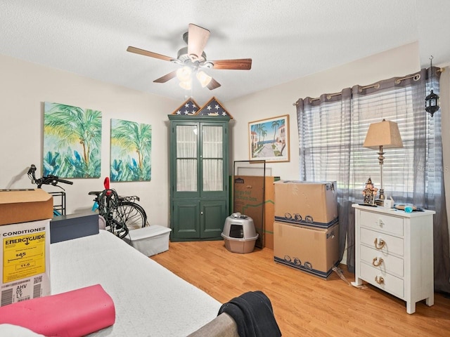 office with ceiling fan, a textured ceiling, and light hardwood / wood-style flooring