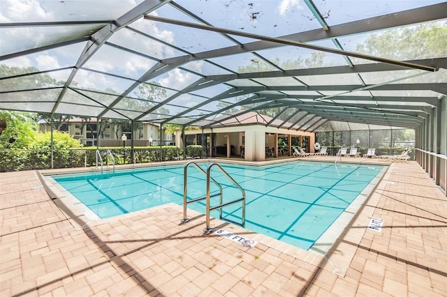 view of swimming pool with a lanai and a patio