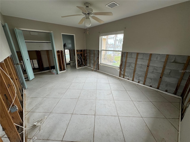 unfurnished room with ceiling fan and light tile patterned floors