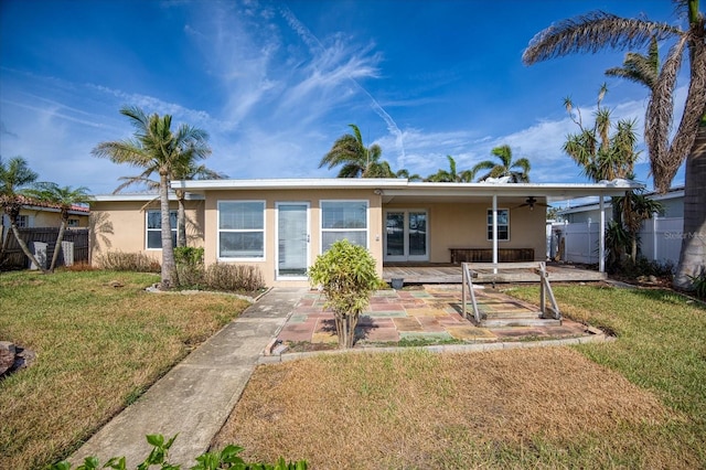 view of front of house with a patio area and a front lawn