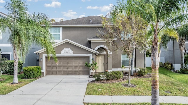 view of front of home with a front lawn and a garage