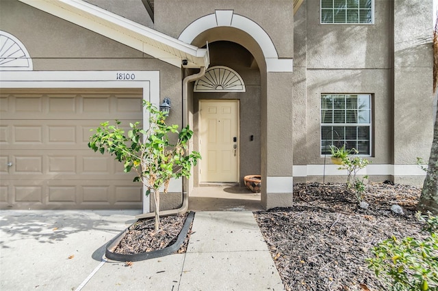 view of exterior entry with a garage