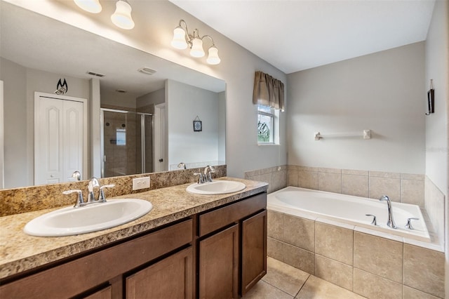 bathroom with shower with separate bathtub, tile patterned floors, and vanity