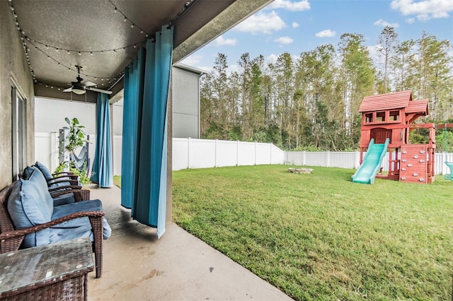 view of yard featuring a playground and ceiling fan