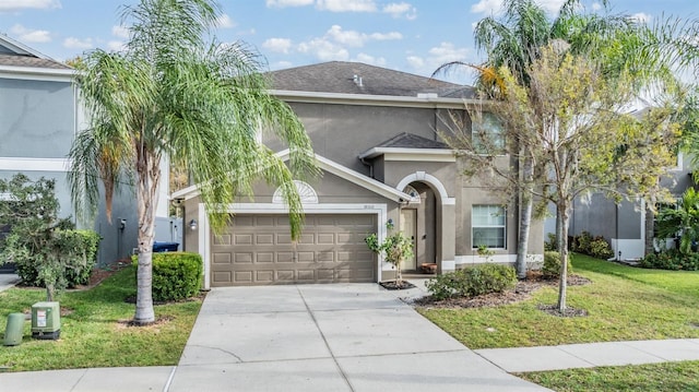 view of front facade featuring a garage and a front lawn