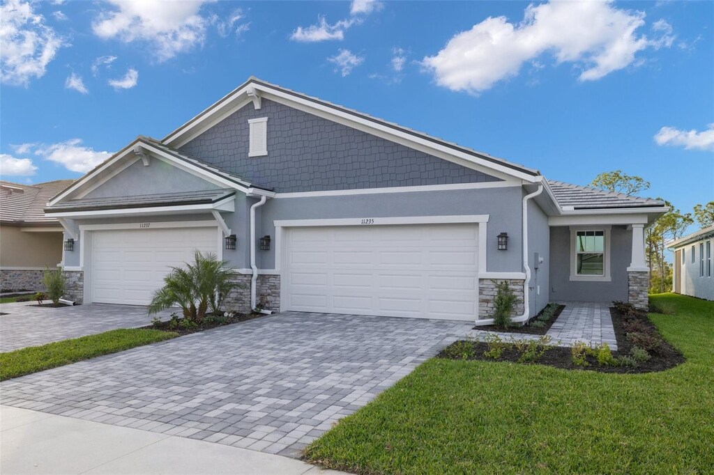 11235 Boundless Ter, Venice, FL 34293 - view of front of home with a garage and a front yard