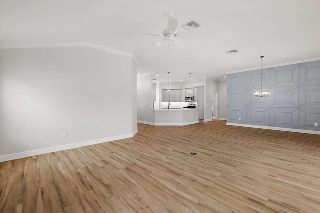 unfurnished living room featuring ornamental molding, sink, ceiling fan with notable chandelier, and light hardwood / wood-style floors