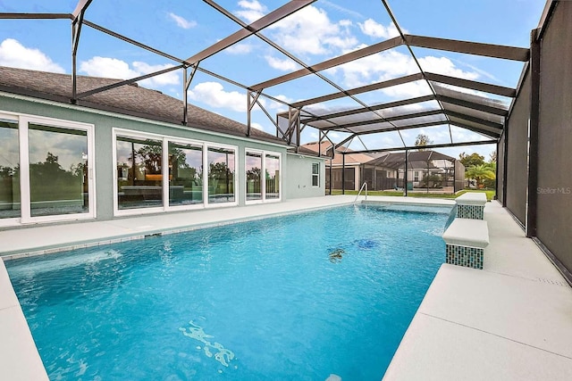 view of swimming pool with glass enclosure and a patio