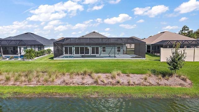 back of house with a water view, a patio, glass enclosure, and a lawn