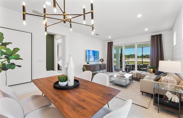 dining space featuring a notable chandelier and light hardwood / wood-style flooring