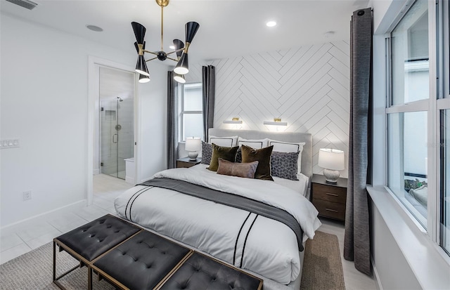 tiled bedroom featuring ensuite bath and a notable chandelier