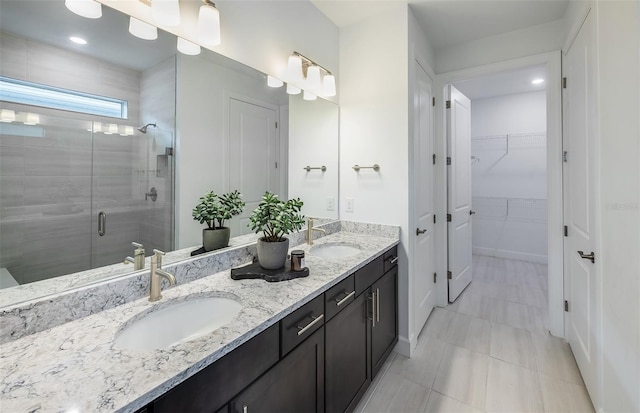 bathroom featuring vanity and a shower with shower door