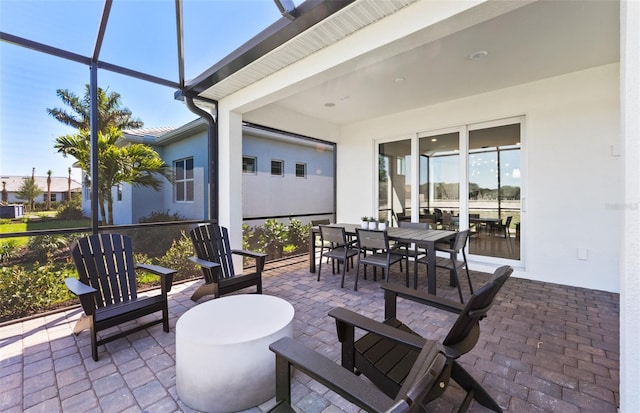 view of patio featuring a lanai