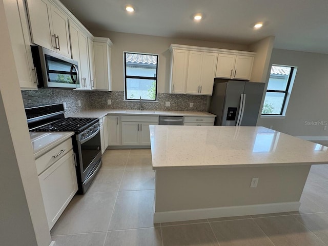 kitchen with white cabinetry, a healthy amount of sunlight, and appliances with stainless steel finishes