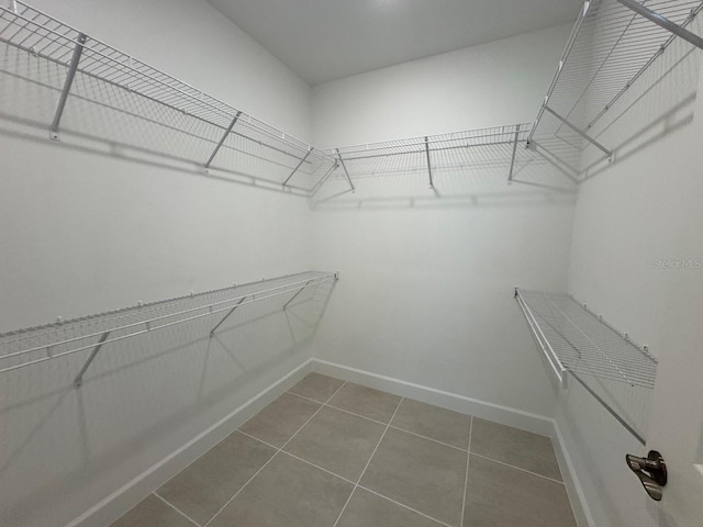 spacious closet with tile patterned flooring